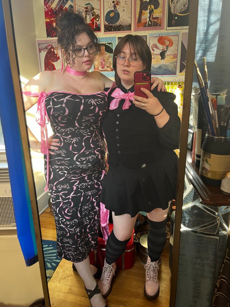 Rachel and I in the mirror in black & pink with pink bows.