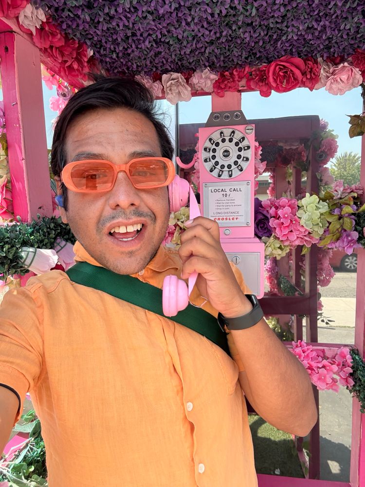 Selfie of me in a pink phone booth. But I’m smiling. 