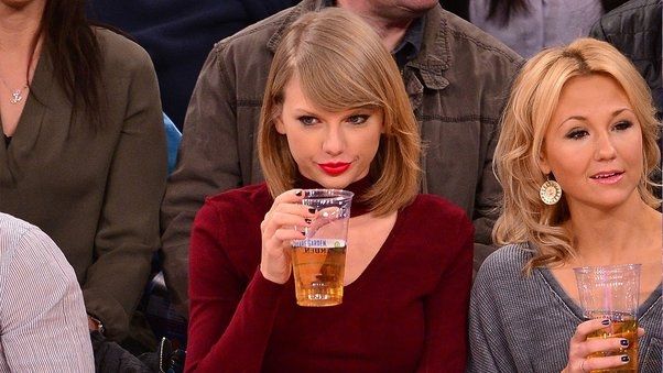 Taylor Swift drinking a beer.