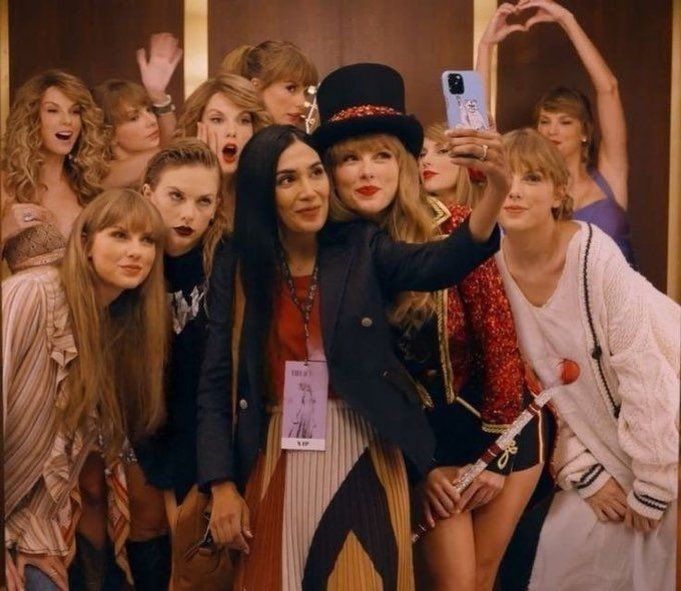 Multiple Taylor's from different eras taking a selfie from the capital one commercial.