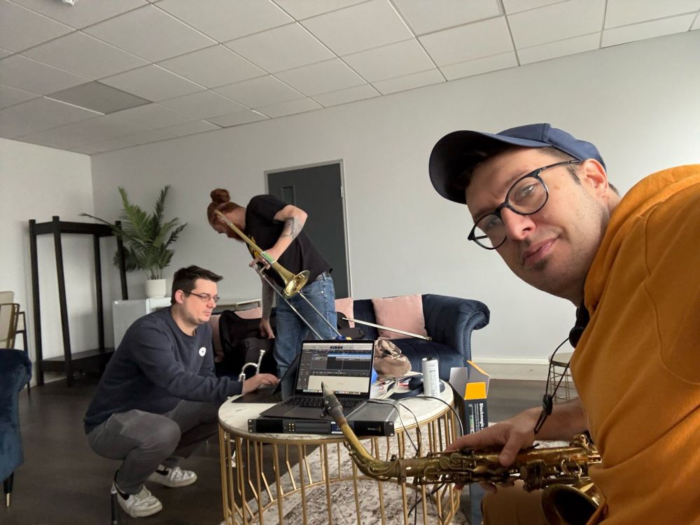 3 brass players having a look at some songs