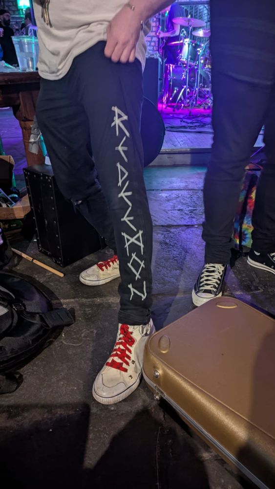 Home made merch trousers with "Redeemon" written on the left leg
