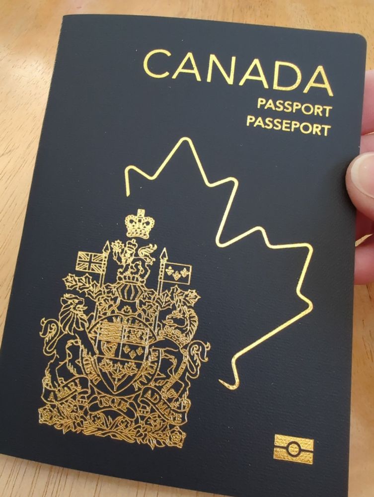 Canadian passport cover, with leaf outline a and Canadian heraldry 