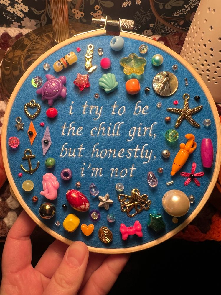 chaotic charm embroidery hoop with lyrics from chappell roan’s song casual: “I try to be the chill girl but honestly i’m not”