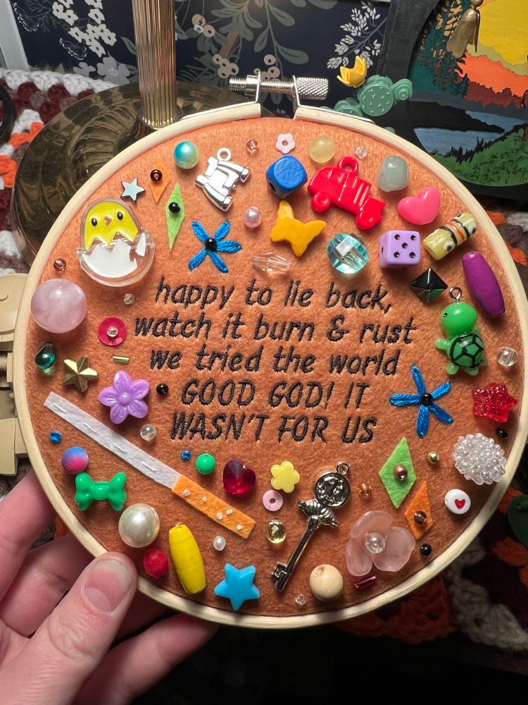 chaotic charm/trinket embroidery piece with lyrics from hozier’s song “jackie and wilson”