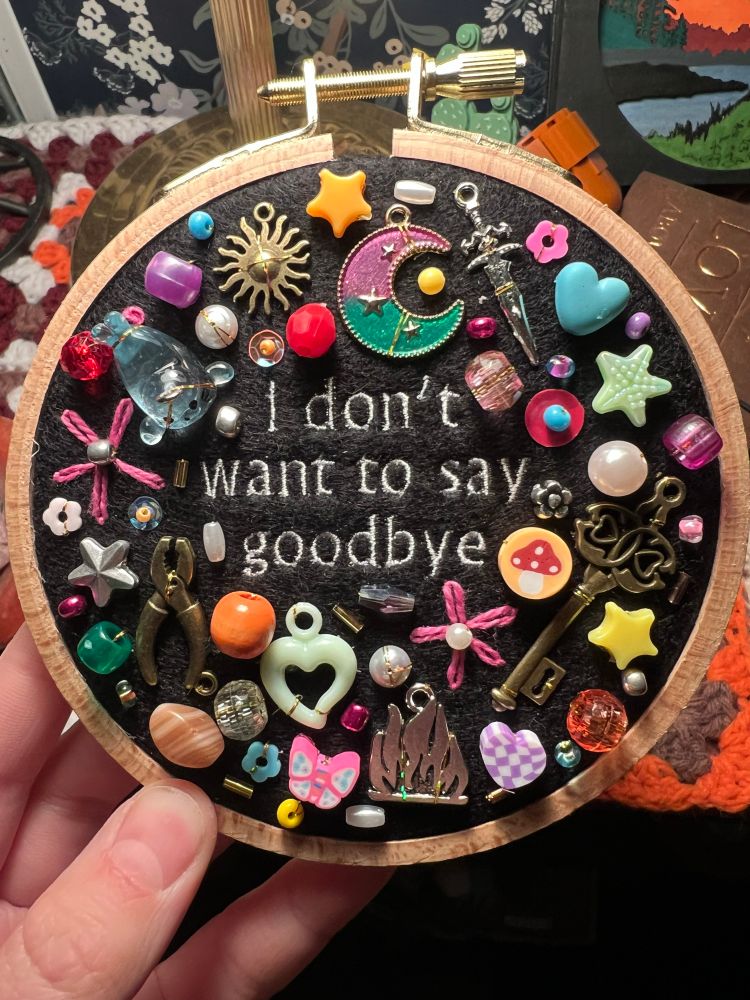 charm embroidery with lyrics from noah kahan’s song “still”
