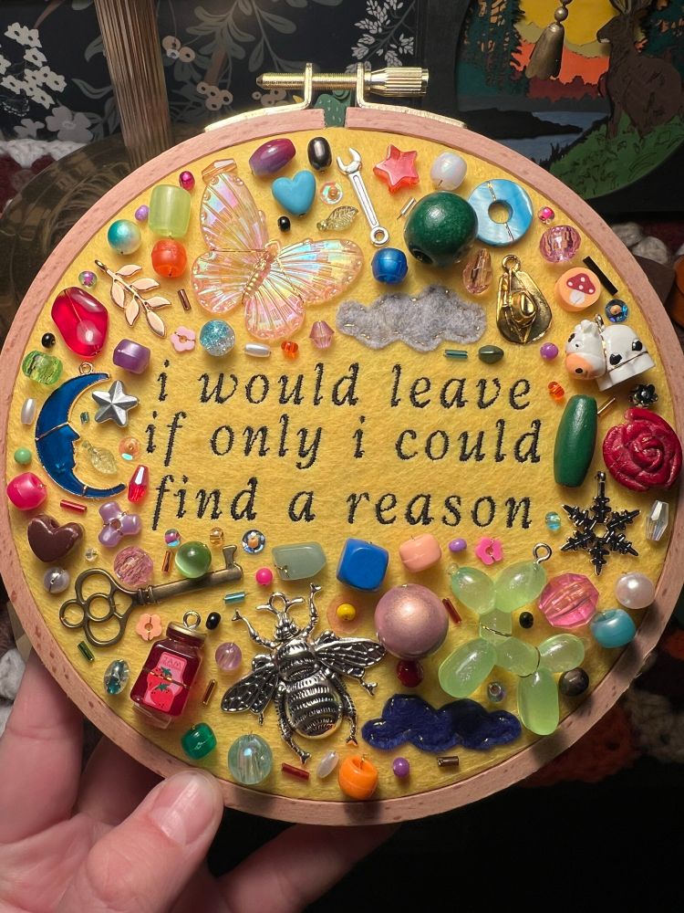 charm embroidery with lyrics from noah kahan’s song “homesick”