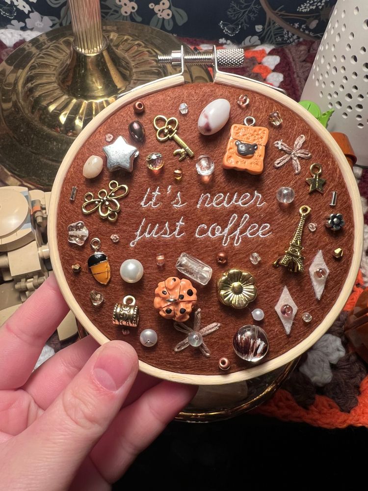 chaotic charm embroidery hoop with lyrics from chappell roan’s song coffee: it’s never just coffee