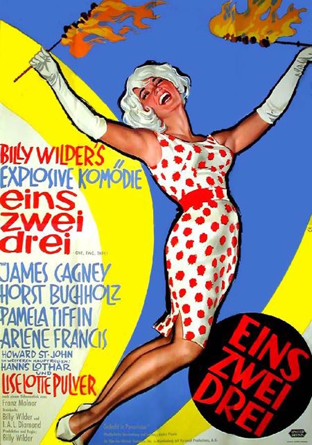 Poster features a picture of a woman in a polka dot dress holding two flaming sticks.  She's in an ecstatic state.