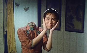 Color photo of a headless woman holding up her detached head.
