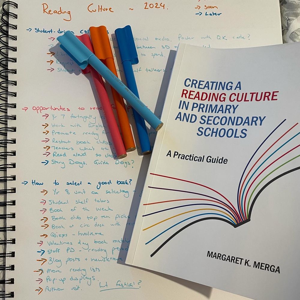 A book, Creating A Reading Culture in Primary and Secondary Schools by Margaret K Merga sitting on top of a notebook with pens