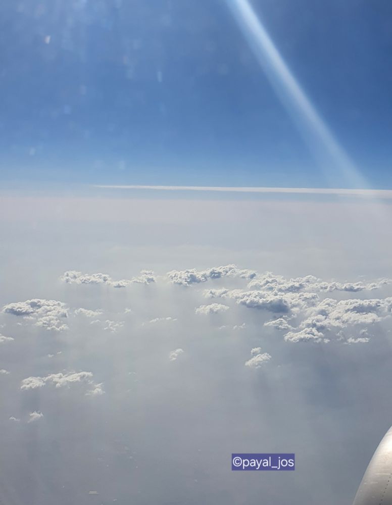 View from plane in-flight overlooking the clouds 