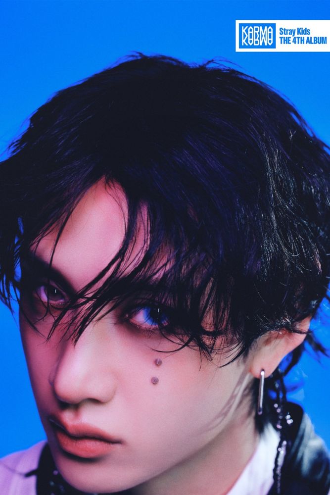 Bang Chan promo for KARMA, in which one of his eyes has an unsettlingly saturated blue contact in. It almost glows under his bangs. He also has some kind of improbable vertical reverse eyebrow piercing under said eye. 