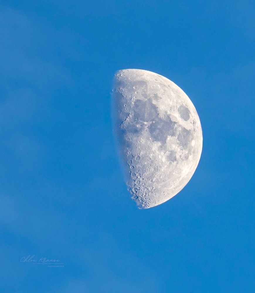 Waxing gibbous moon in a blue sky
