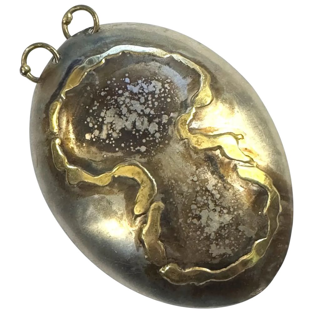 A very large vintage 1960s 70s one of a kind handmade mixed metals (brass, steel) heavily patinated abstract modernist brutalist pendant by studio jeweler Lascaux from Quebec, Canada. Entirely handmade no doubt one of a kind creation by a talented designer and craftsman! An overall dimensional oval shape that rises outward in steel with an applied figure 8 or infinity symbol inside of which is a splattered-looking brown patina reminiscent of abstract expressionist artworks. Two bronze hoops at top for adding a chain or neckring or a cord! Measures 3.5" tall by 2.5" wide. The hoops at top will accommodate a good-sized chain or neckring up to about 1/4" wide, or just about any fabric cord you like. Marked at back, "Lascaux" for the artisan-jeweler from Quebec. A spectacular one of a kind piece of vintage wearable art! I can provide a fabric cord free of charge if you need one, just let me know when you're making the purchase. Excellent vintage condition.