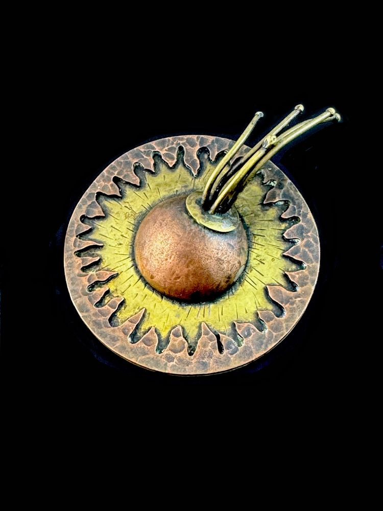 A sculptural one of a kind vintage 1960s 70s signed handmade mixed metals (sterling, copper, bronze) modernist dimensional design brooch pin. Such a unique piece unlike anything that I've seen before! A ring of jagged copper that resembles flames over a gilded bronze section with etched details, and from which emerges a copper dome on one side of which is a bronze disk from which emerges several bronze bead-tipped wires. I can't help but think that this is some kind of celestial model, maybe a sun flare, or a comet sinking into the sun? Or maybe an abstract composition with no figurative message. I can't say for sure, but the craftsmanship is astounding! Measures 3-1/8" widest by 2.5" diameter by about 1" depth at thickest point. Marked at back with cutout crescent moon shape and a dot, an unusual maker mark that I haven't seen before. No doubt originally sold in an art gallery or fair with accompanying paperwork or labeling for the maker that has been lost over the years. In any case, a fantastic one of a kind piece of wearable modernist art by a talented designer/metalsmith! Excellent vintage condition.