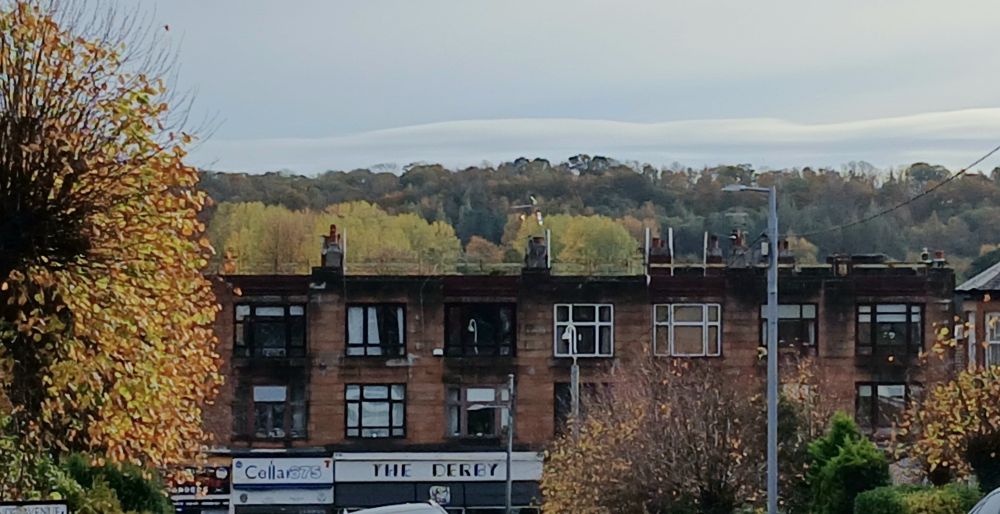 View looking downhill towards the Derby cafe. There's an autumnal treescape behind the building