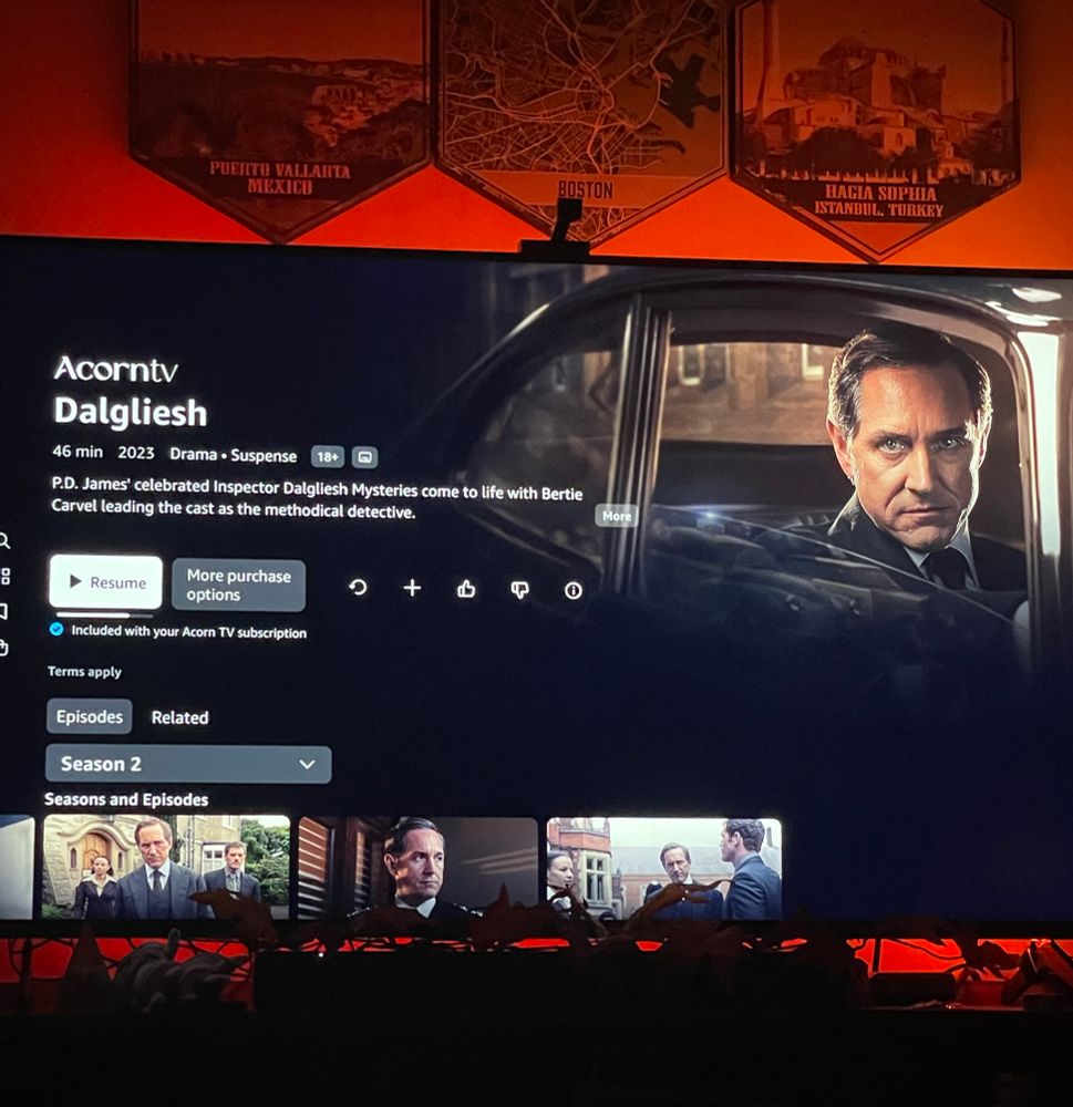 A widescreen TV backlit in orange, showing the main splash screen for the show Dalgliesh