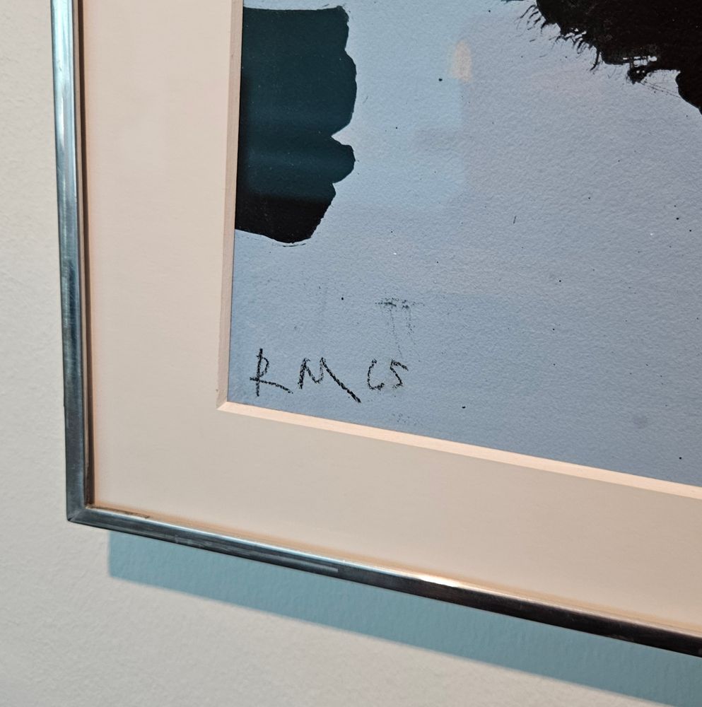 Corner of a painting with RM on a blue canvas