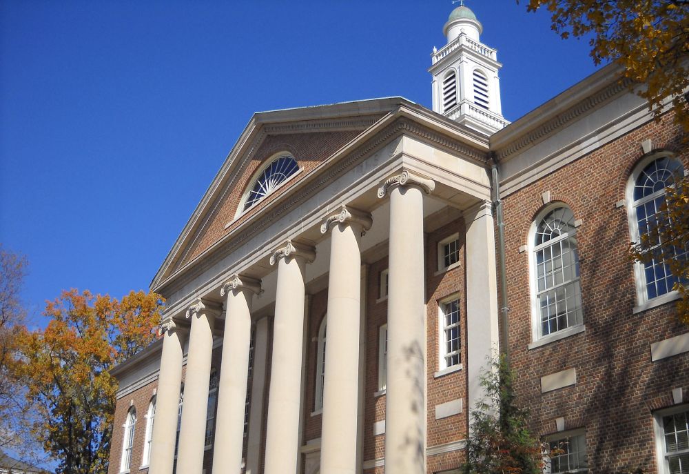 Historic Manning Hall building at UNC with bright blue sky