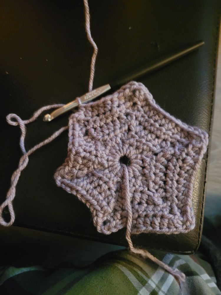 A yarn hexagon made of half double crochet stitches with a 6mm hook 