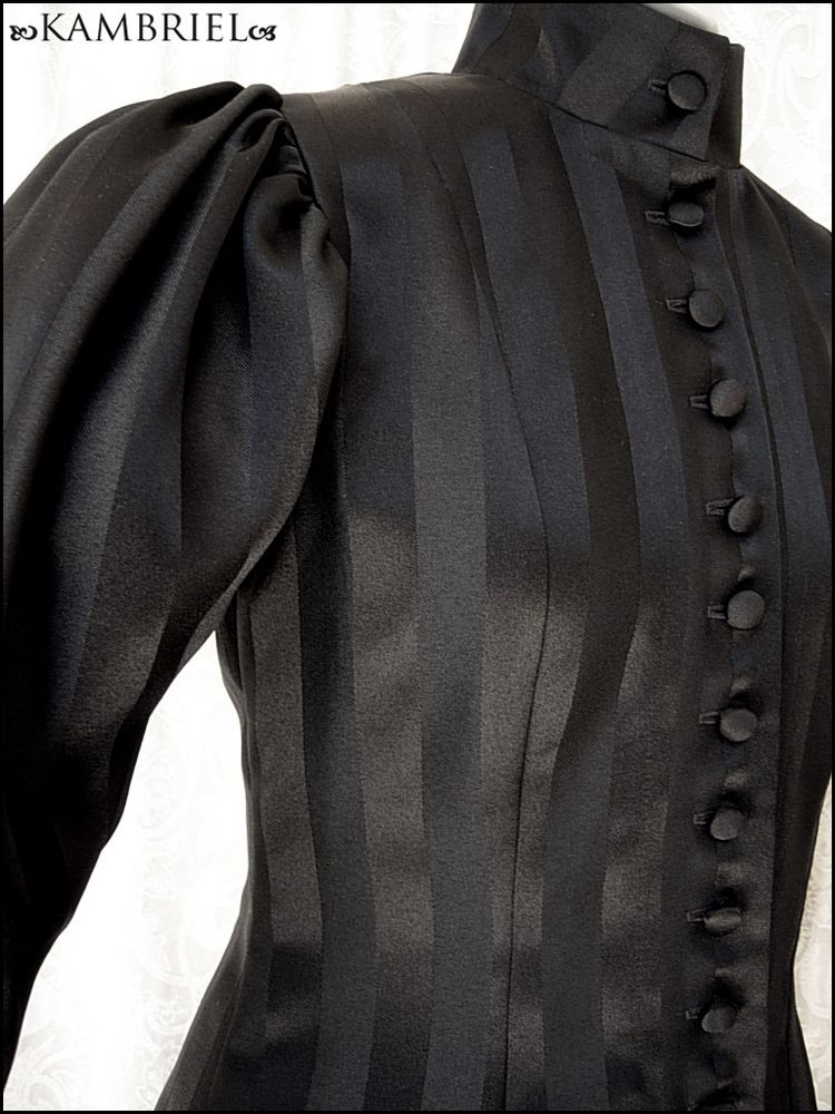 Elegant fit & flare coatdress by Kambriel (www.kambriel.com & kambriel.etsy.com), made from black on black striped matte satin, with modified leg o'mutton sleeves, high neck & a plethora of matching handcovered buttons down the front.