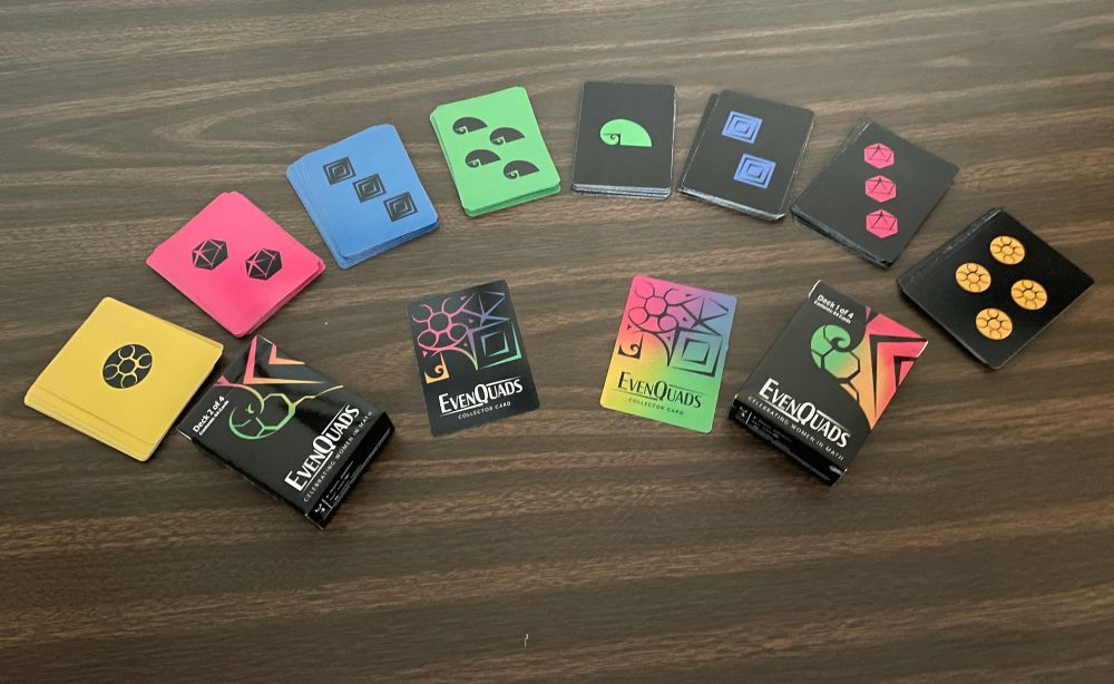 Fan of colorful cards with their tuckbox for EvenQuads