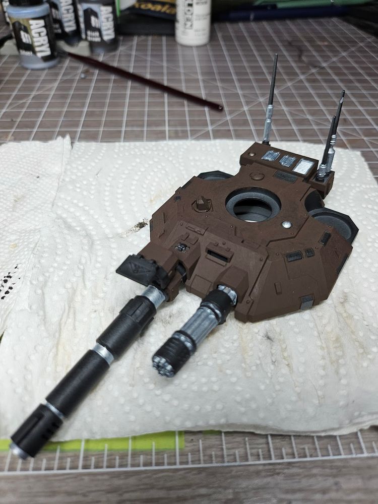 The turret of a 40k repulsor tank painted in dark brown, silver, and black. Still in it's initial stages of paining