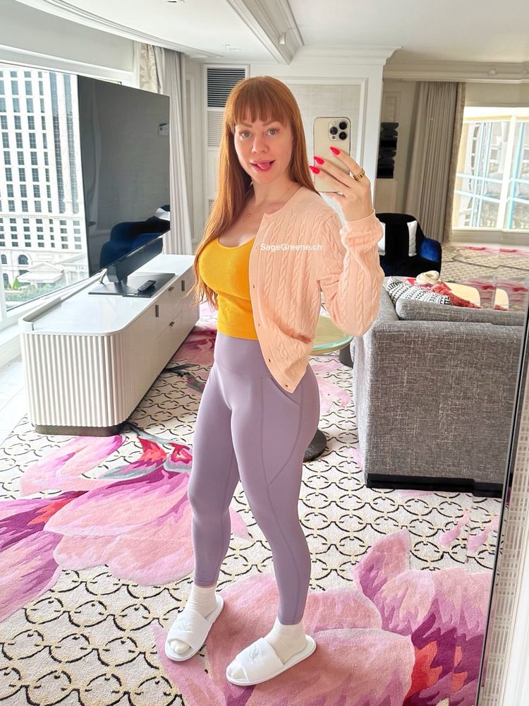 Redhead woman taking mirror selfie.