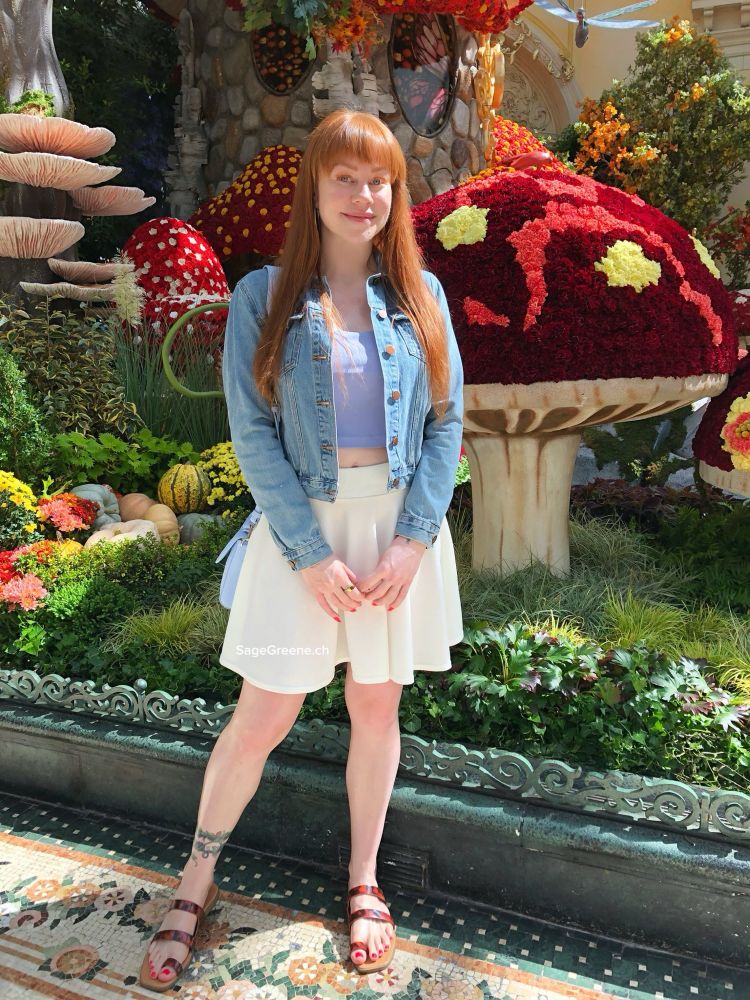 Redhead woman posing at the Bellagio Conservatory’s autumn display.