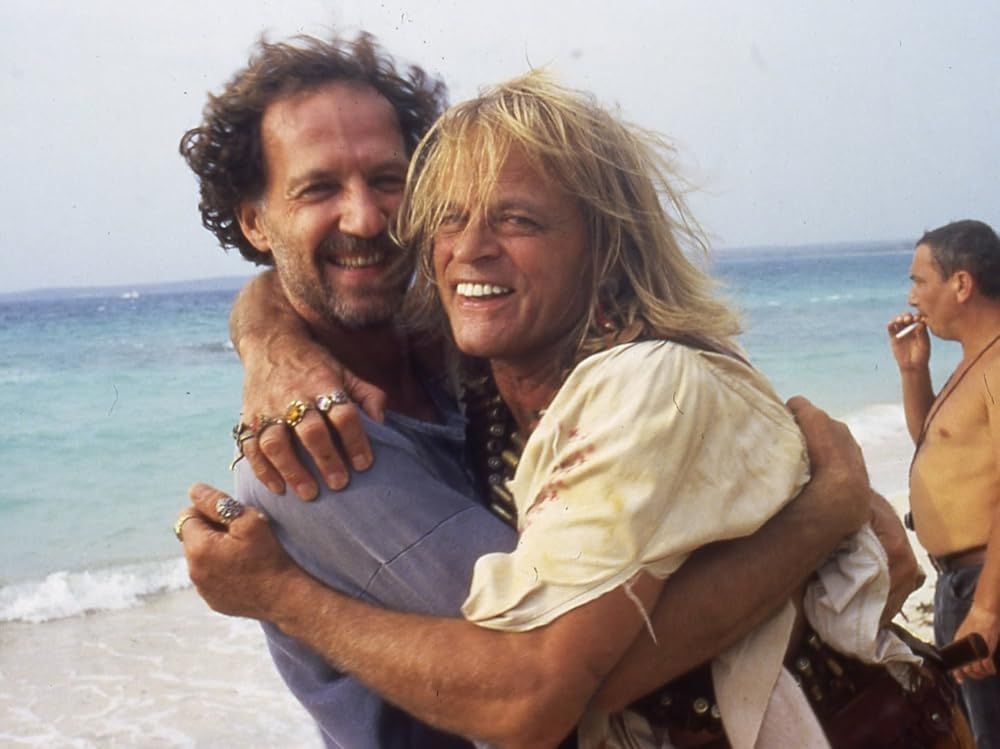 Werner Herzog and Klaus Kinski giving each other a playful hug on the set of Cobra Verde.