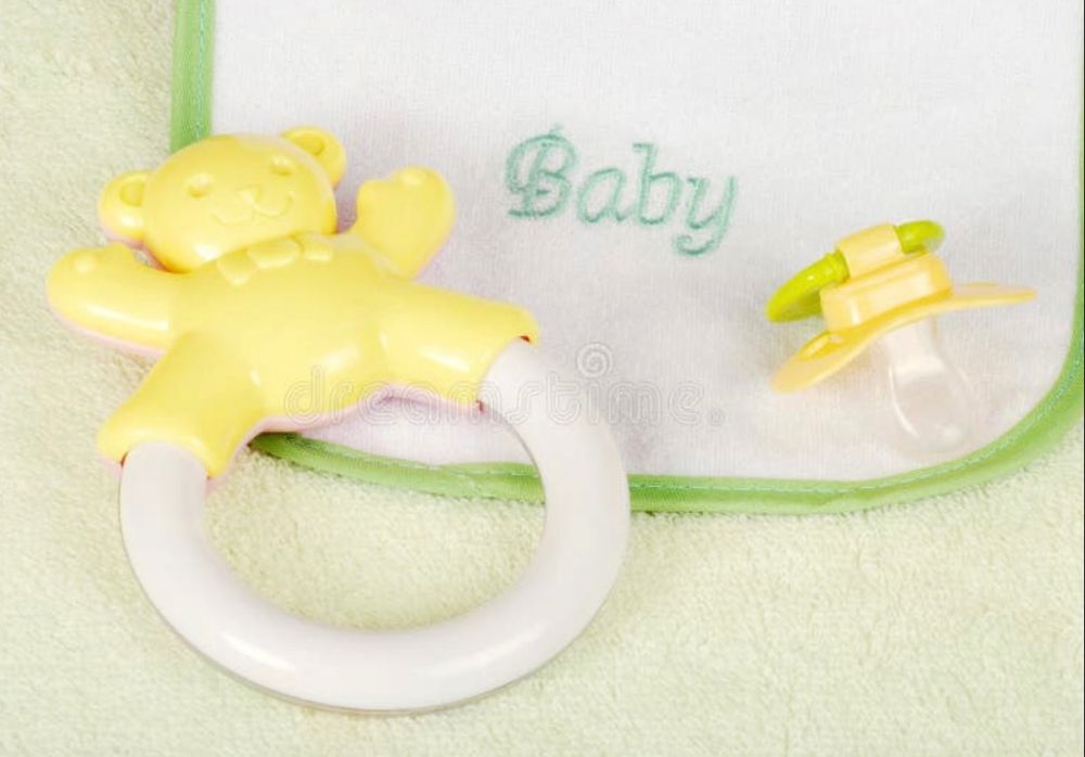 Baby bib, pacifier and rattle