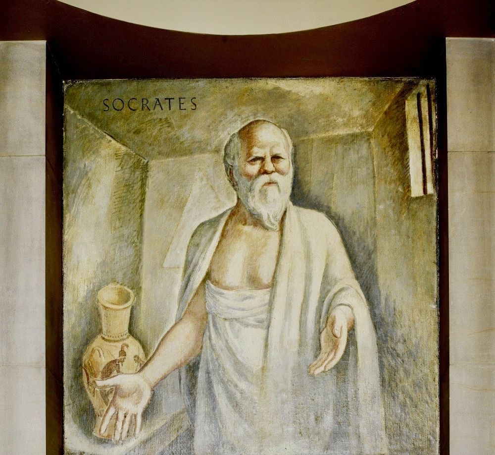 Socrates’ Boardman Robinson. Mural. Oil on canvas. Department of Justice Building, Washington DC. 1937.
Carol M. Highsmith Photography
‘Socrates (469-399 BCE) – At the basis of his teachings, the Greek philosopher Socrates advocated for a purely objective understanding of concepts such as justice and virtue. He also emphasized rational argument and knowing one’s true self. Socrates’ philosophy is recorded in the writings of his pupil, Plato, and Plato’s pupil, Aristotle. Robinson depicts Socrates in a prison cell at the end of his life, awaiting execution for impiety and corruption. Behind him, a Greek vase possibly contains the poisonous hemlock he was sentenced to drink.’
https://www.gsa.gov/fine-arts#/artist/114 
