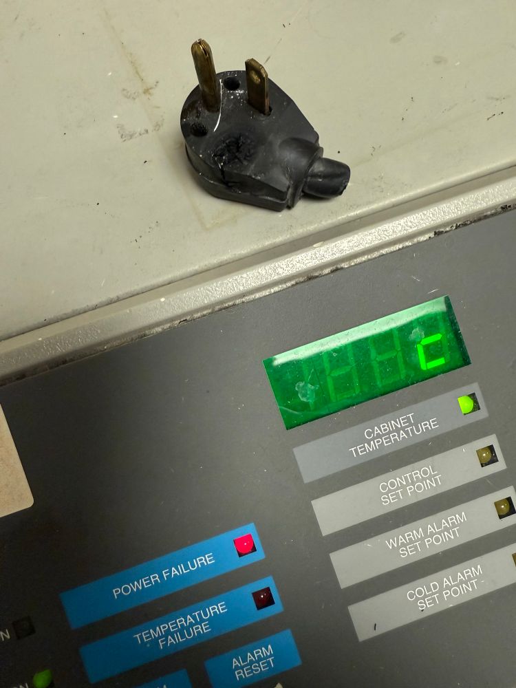 A dead -80C freezer with a burned out plug