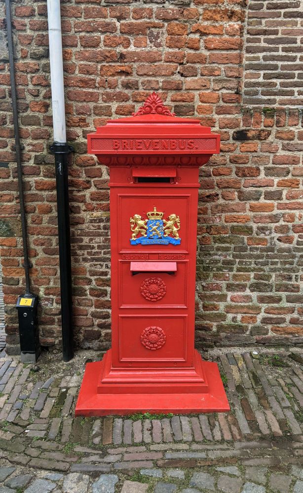Photo depicting an old-fashioned red mailbox in Deventer, Netherlands.