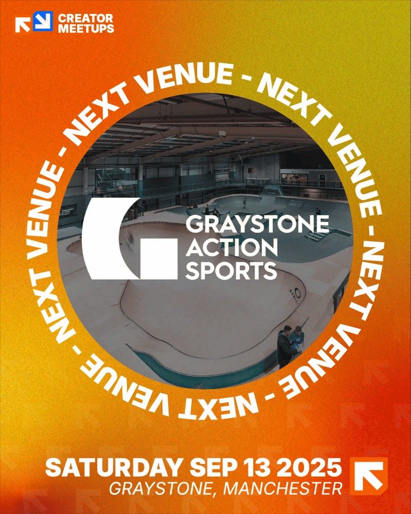 A vibrant orange and yellow graphic announcing the next Creator Meetups venue. The center features a circular cutout showing an indoor skatepark with ramps and a bowl. Overlaid in white text is the Graystone Action Sports logo. Surrounding the cutout, the words 'NEXT VENUE' are repeated in a circular pattern. At the bottom, bold white text states 'SATURDAY SEP 13 2025' with 'GRAYSTONE, MANCHESTER' in smaller italicized text below. The Creator Meetups logo is in the top left corner.