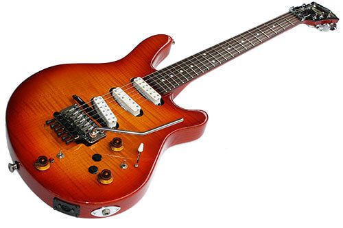 The Washburn JB100 is the signature model for Jennifer Batten. It's shaped similar to a Strat and has three pickups in the Strat configuration, although they're actually humbuckers shaped like single-coils. There's a volume and a tone control, a 5-way blade switch, and a coil tap switch. There's also a Roland GK-2A synth pickup between the bridge pickup and the bridge itself, and it's got its own switch and volume knob, as well as a light to tell you if it's on or not as well as what looks like two pushbuttons to control it. (I'm guessing that's what they're for; I haven't been able to find a manual for this guitar.) The guitar has a MIDI output to go with the normal 1/4 inch one, and it's got a double locking trem and a 3/3 split headstock.