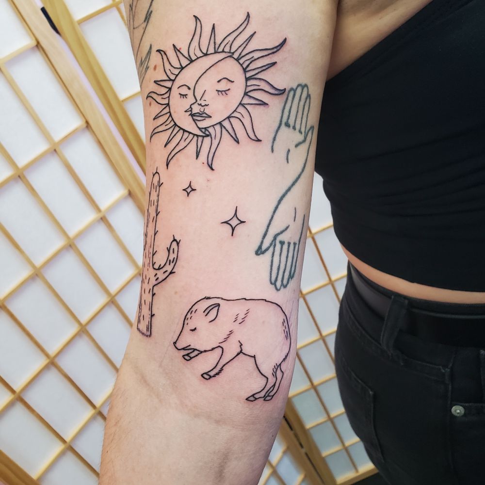 Inner lower upper arm tattoo of a javalina