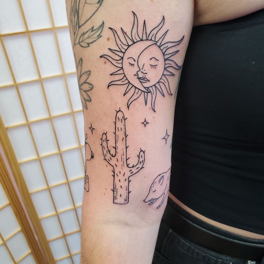 Shot showing a cactus under a moon/sun comb