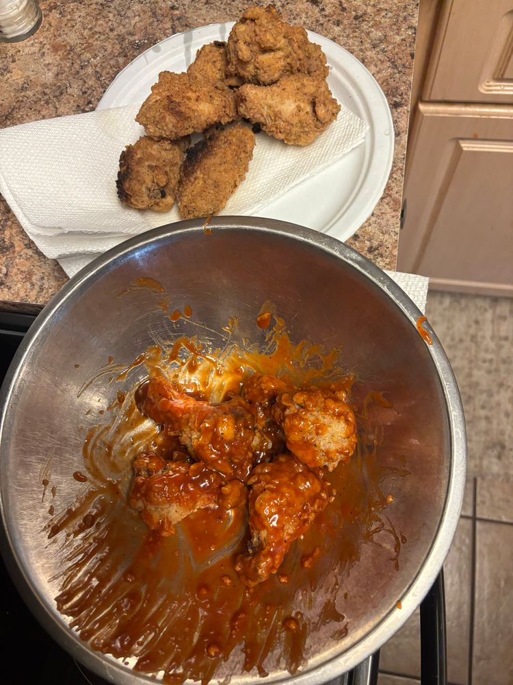 Directly beneath you are for drums in a buffalo/barbecue sauce. On top of those in the picture are a half a dozen breaded but unsauced wings.