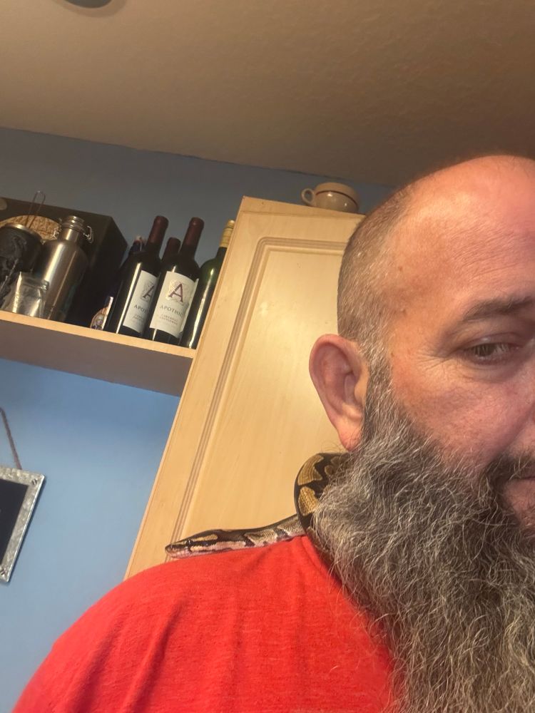 A doofus with a small python around his neck. 