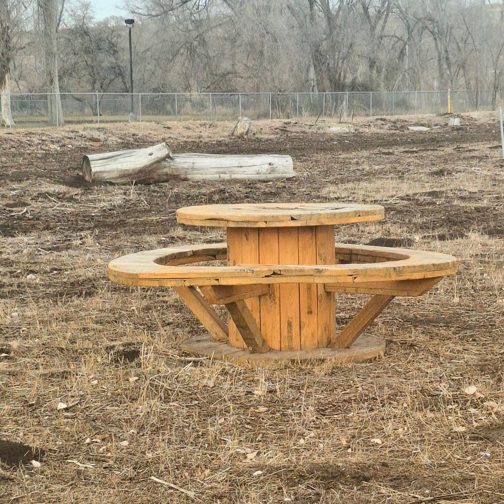 Round wooden table in a field