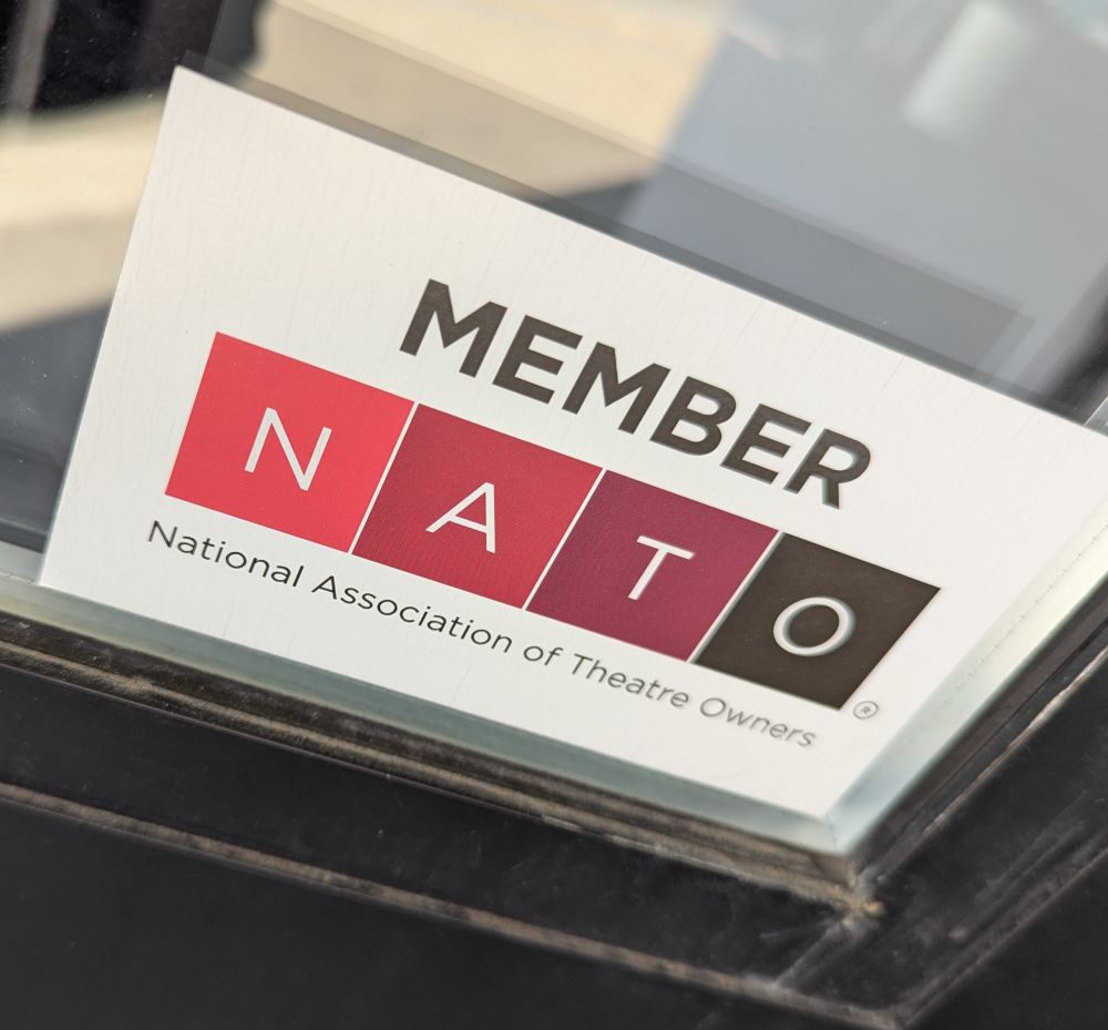 A sticker on a window that reads:

MEMBER
NATO
National Association of Theatre Owners