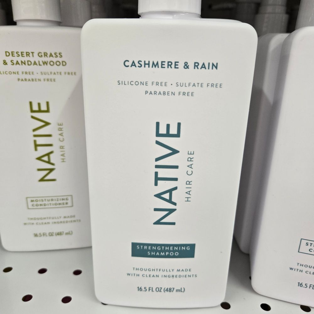 A bottle of Native brand shampoo in the scent Cashmere and Rain. 