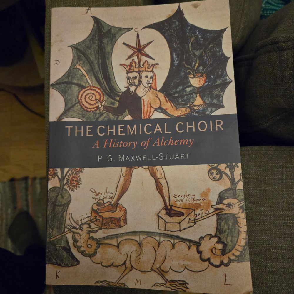 Book cover of The Chemical Choir. A drawing of a hermaphroditic figure with wings and a crown stands on two pieces of stone while a dragon with a head at each end passes below. 