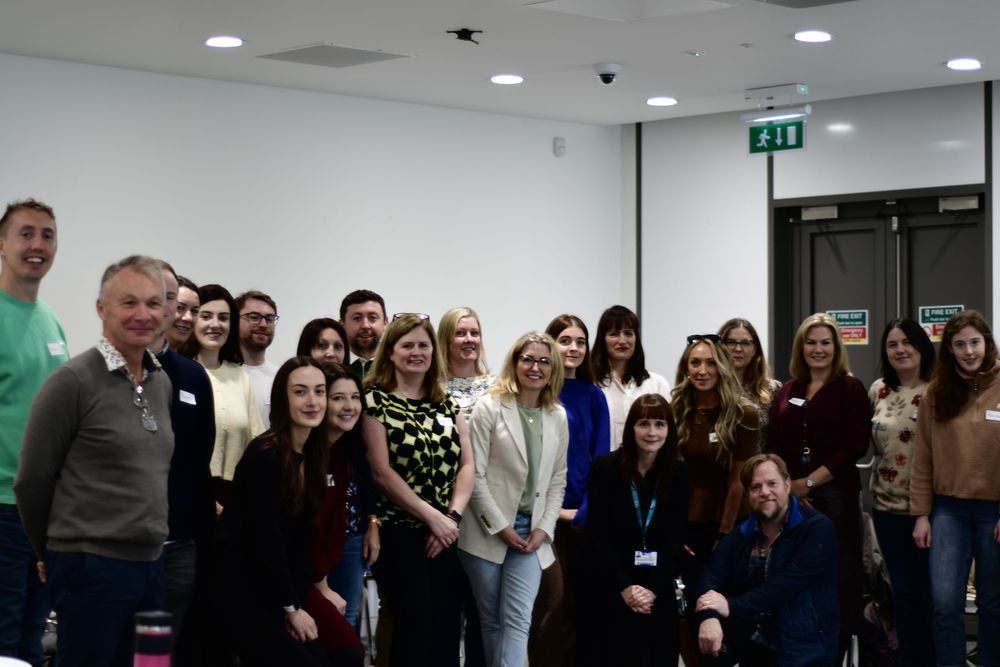A group of students stand together in a classroom for a photo. These students are the first group of students undertaking the Doctorate in Educational Psychology. 