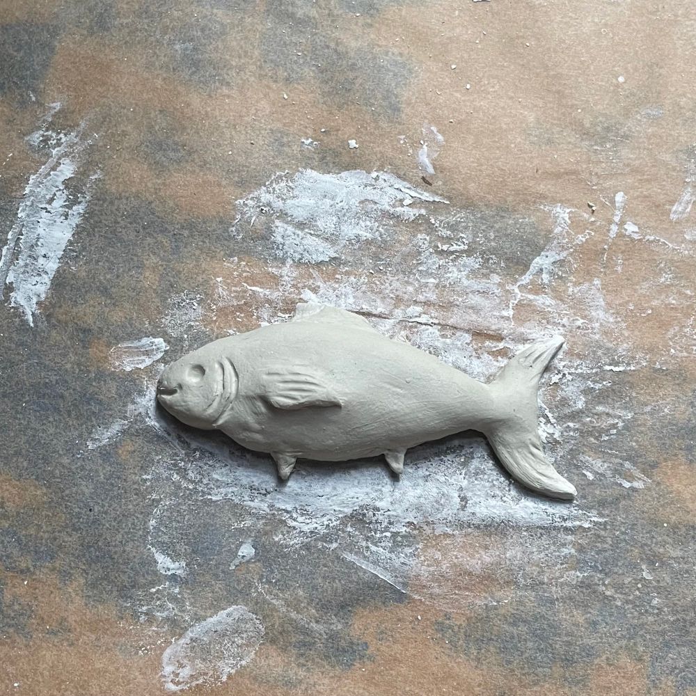 a clay figurine of a tuna fish