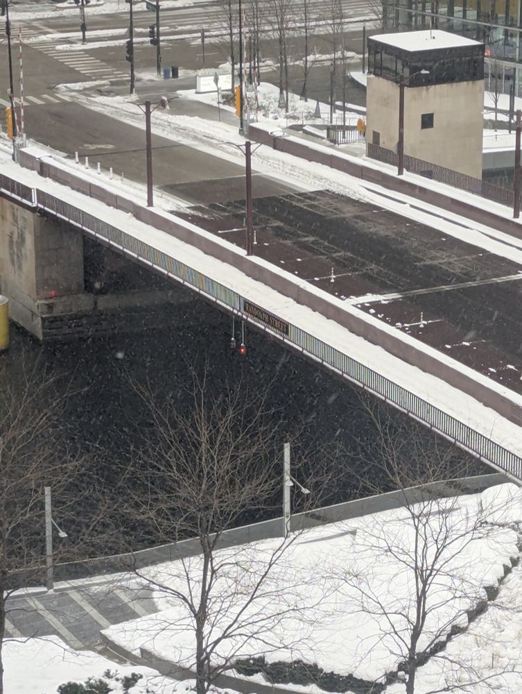 Randolph Street bridge with clear lanes for cars, but snowy sidewalks and bike lanes. 