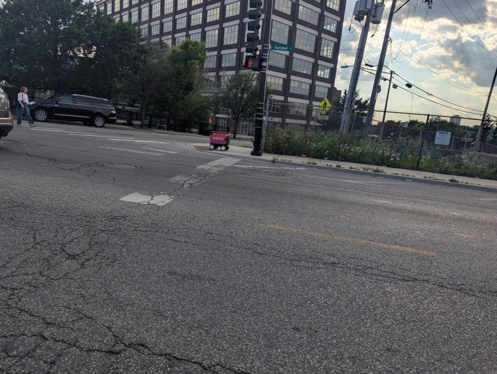 Coco bot going north on Halsted, basically the same pace as the woman crossing the street behind it. 