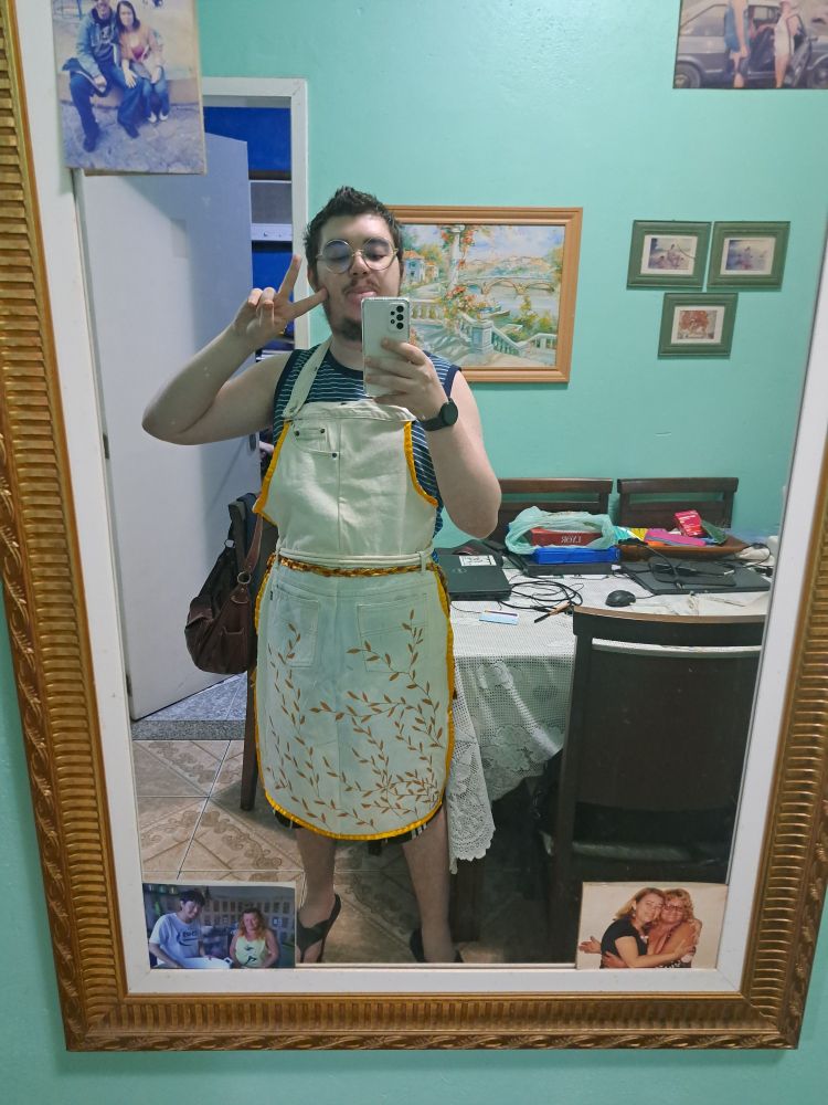 Me, wearing a white jeans apron with a gold rim. By the waist, there's a braid made of copper and golden ribbons, and by the bottom vines are painted in a golden paint.